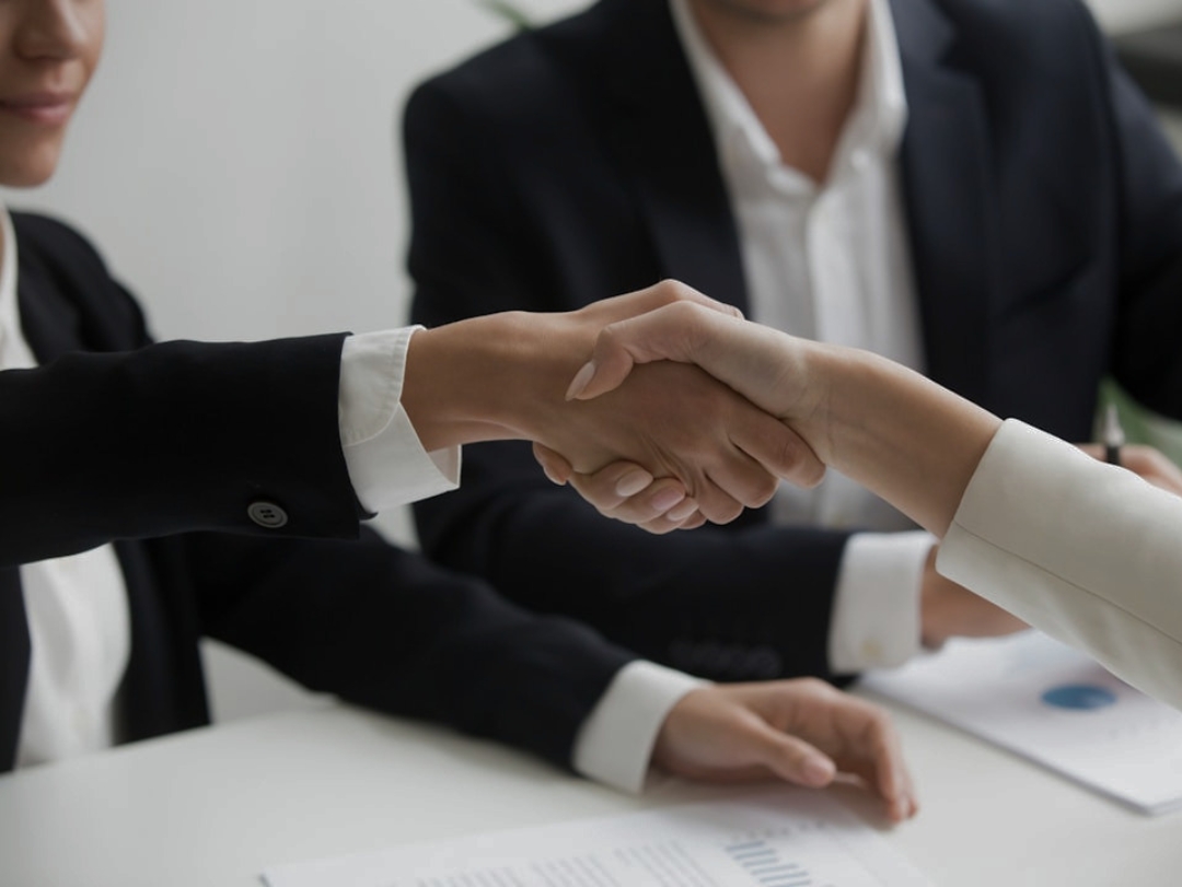 A professional handshake between a fund manager and an investor, symbolizing a successful real estate investment partnership with Aspen Sage Investment Fund.