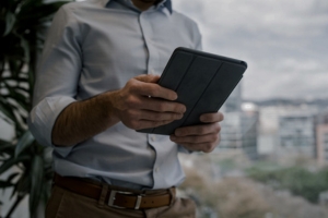 An investor accessing the Aspen Sage Investment Fund portal on a tablet to oversee real estate portfolio performance.